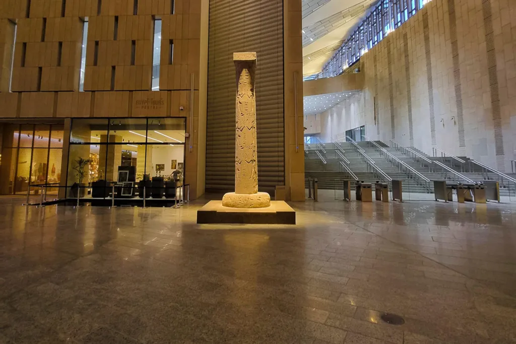 The Hanging Obelisk of King Ramses II at the Grand Egyptian Museum entrance, showcasing ancient carvings and modern design.