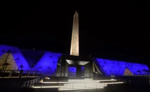 Hanging Obelisk of King Ramses II illuminated at night in the Grand Egyptian Museum entrance courtyard, unique architecture.