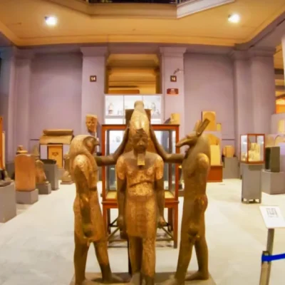 Ramesses III statue between gods Horus and Set in the Egyptian Museum, showing detailed ancient stone carvings and royalty.